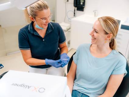 Frau Dr. Schmid zeigt Patientin Zahnschiene